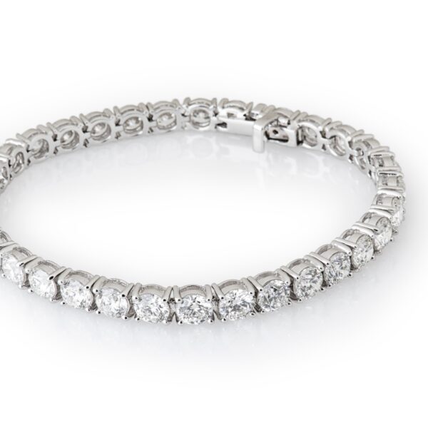 Diamond tennis bracelet on white background.